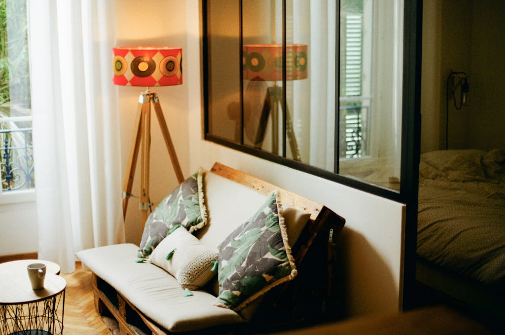 Cozy living room with modern décor featuring a unique lampshade, sofa, and decorative pillows.