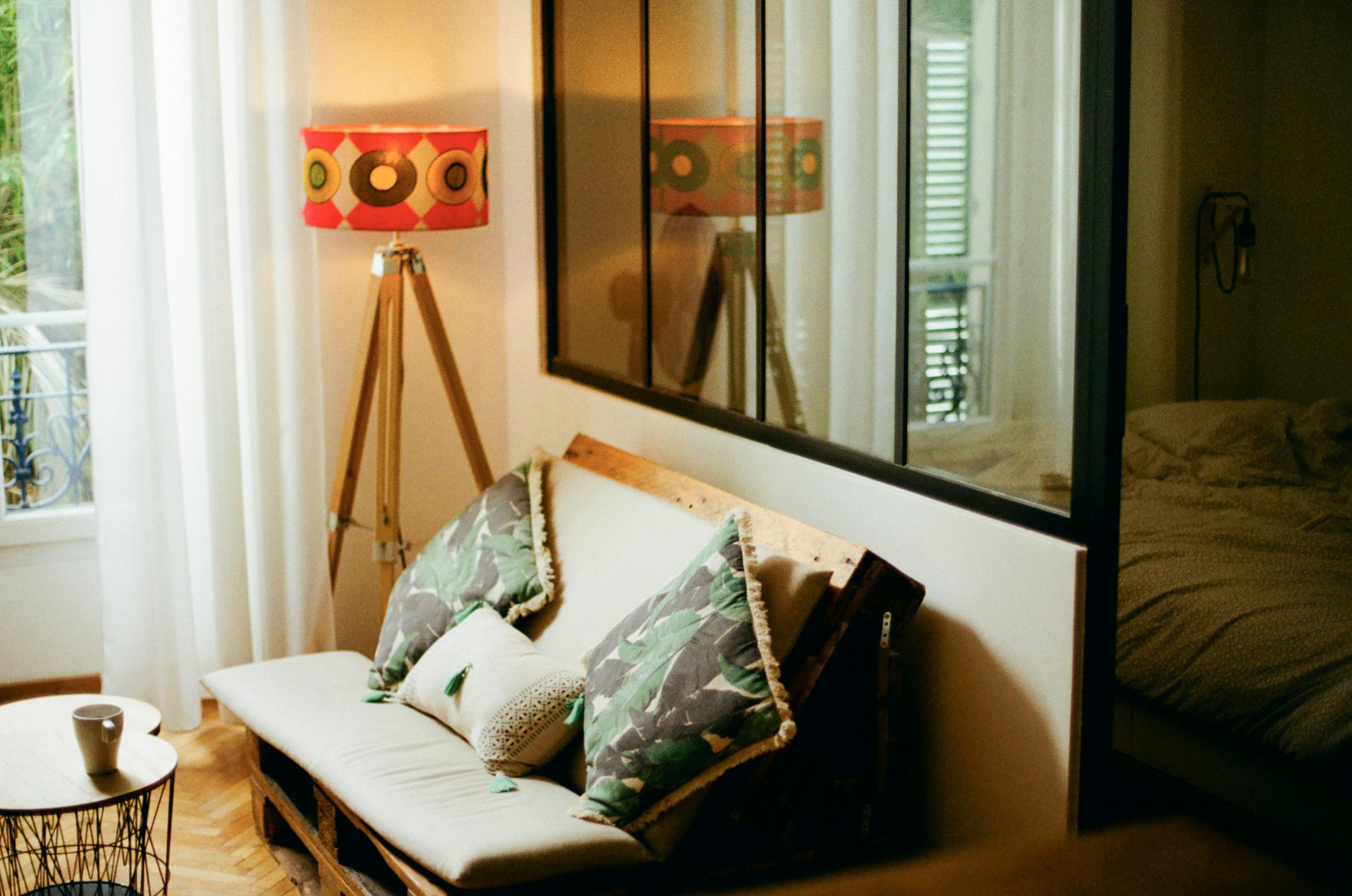 Cozy living room with modern décor featuring a unique lampshade, sofa, and decorative pillows.